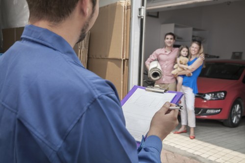Removalists carrying furniture through a modern Docklands apartment entrance