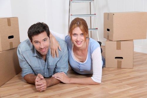 Movers handling items in a Docklands high-rise building near lift access